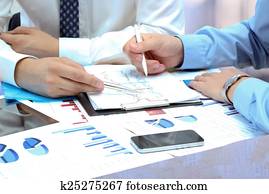 business colleagues working together and analyzing financial fig