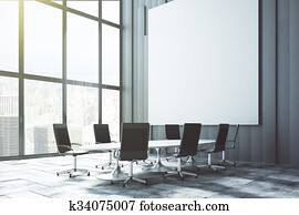 Big white blank poster on the wall in loft conference room at sunrise, mock up Big white blank poster on the wall in loft conference room at sunrise, mock up