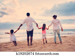 Family Having Fun on Beach at Sunset Family Having Fun on Beach at Sunset