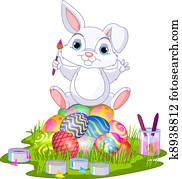 Easter. Bunny sitting on eggs