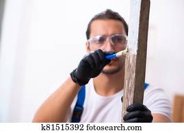 Young male contractor working in workshop Young male contractor working in workshop