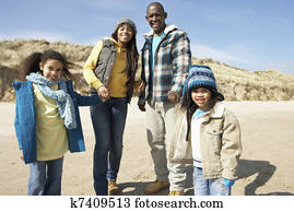 Family Walking On Winter Beach Family Walking On Winter Beach