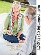 Senior Woman Playing Dominoes With Man Senior Woman Playing Dominoes With Man