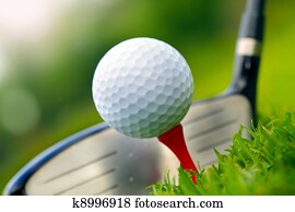 Golf club and ball in grass 