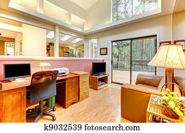 Home office interior with large windows.