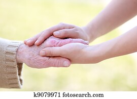 Senior and Young Women Holding Hands