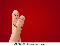 A happy couple in love with painted smiley and hugging A happy couple in love with painted smiley and hugging