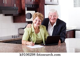 happy senior couple checking retirement investment happy senior couple checking retirement investment
