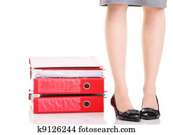 Businesswoman legs pile of ring binders reast break