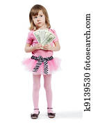 Little girl in pink with dollar banknotes in her hands.