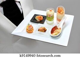Catering waiter with canapes on pla Catering waiter with canapes on pla