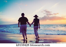 Senior Couple Enjoying Sunset at the Beach