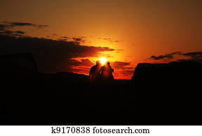 couple holding each other during a sunrise 