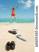 businessman jumping on the beach