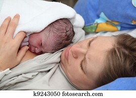 Newborn baby with mother minutes after the birth Newborn baby with mother minutes after the birth