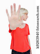 Woman trying to escape making the stop sign with hand while leaning her head