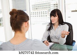 A business woman interviews a potential new employee A business woman interviews a potential new employee