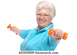 Senior woman working with weights in gym Senior woman working with weights in gym