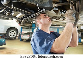 auto mechanic at car suspension repair work auto mechanic at car suspension repair work