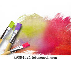 Artist brushes with a half finished painted canvas Artist brushes with a half finished painted canvas