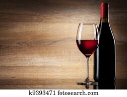Wine glass and Bottle on a wooden background Wine glass and Bottle on a wooden background