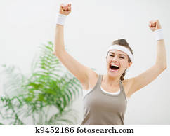 Happy sporty girl rejoicing success