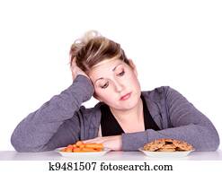 Woman on diet making eating choices Woman on diet making eating choices