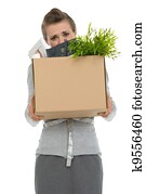 Fired woman employee hiding behind box with personal items