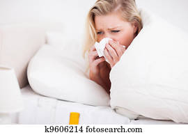 Blonde woman sneezing