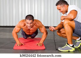 fitness man and personal trainer in gym fitness man and personal trainer in gym