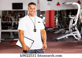 handsome male personal trainer in gym handsome male personal trainer in gym