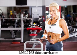 happy young female gym personal trainer happy young female gym personal trainer