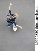 overhead view of teen boy skateboarding