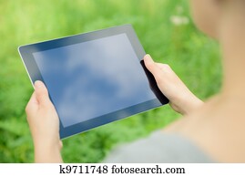 Holfing digital tablet in hands