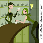 A saleswoman at counter showing products to a customer A saleswoman at counter showing products to a customer
