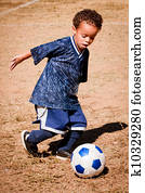 African American boy playing soccer
