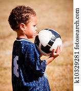 African American boy playing soccer