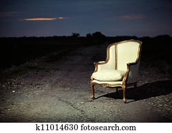 antique chair let on the road