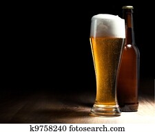 beer glass and bottle on a wooden table