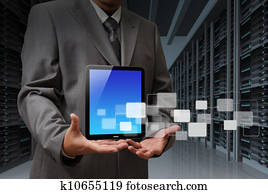 business man and tablet computer in server room