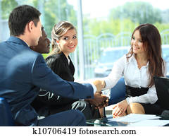 Business people shaking hands, finishing up a meeting Business people shaking hands, finishing up a meeting