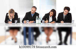 Business people taking notes at the meeting