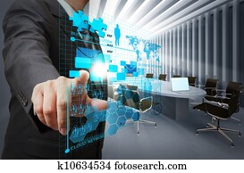 businessman hand point on virtual business network in board room