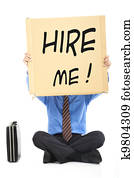 Businessman holding the text Hire Me Businessman holding the text Hire Me