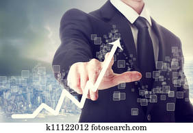 Businessman Touching a Chart Indicating Growth