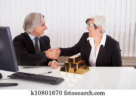 Businesswoman with gold bullion bars