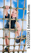 Child climbing on playground Child climbing on playground