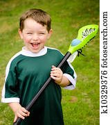 Child playing lacrosse at park Child playing lacrosse at park
