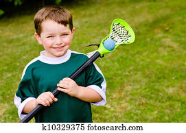 Child playing lacrosse at park Child playing lacrosse at park
