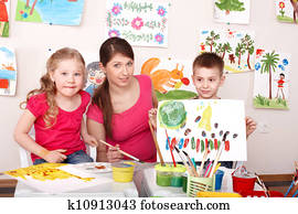 Children painting with teacher in art class. Children painting with teacher in art class.